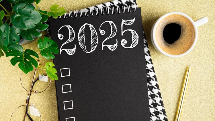 New year resolutions 2025 on desk. 2025 resolutions list with notebook, coffee cup on table. Goals, resolutions, plan, action, checklist concept. New Year 2025 template. Copy space