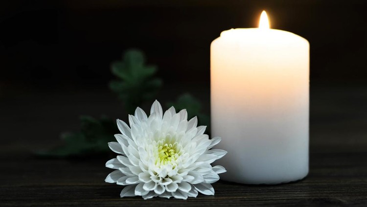 Burning candle and white Chrysanthemum flower
