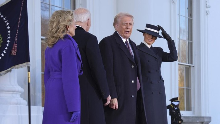 President Joe Biden, center left, and first lady Jill Biden, left, speak with President-elect Donald Trump, center right, and Melania Trump, right, upon arriving at the White House, Monday, Jan. 20, 2025, in Washington. (AP Photo/Evan Vucci)
