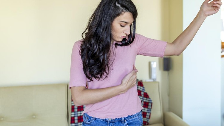 A beautiful young woman is suffering from pain in the breast. She is touching her body to check that everything is ok. BSE or Breast Self-Exam. Guidelines to check for breast cancer.