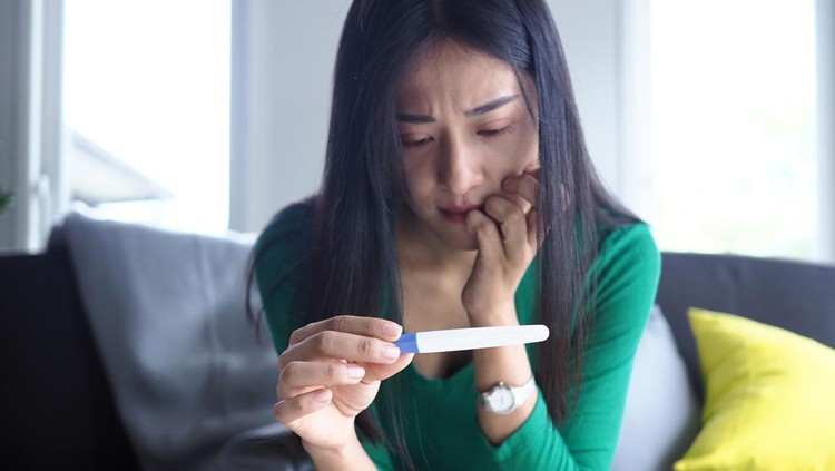 Asian beautiful women are stressed and worried about pregnancy results. Pregnancy beyond expectations in teenagers