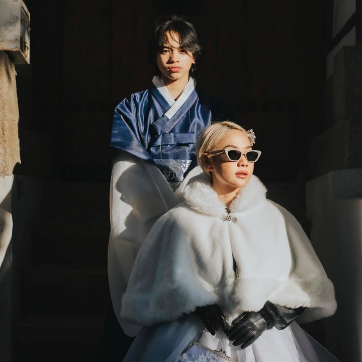 <p>Di momen liburan kali ini, BCL juga mengunggah foto saat mengenakan pakaian tradisional Korea, Hanbok. BCL tampil cantik mengenakan Hanbok modern berwarna putih, sementara sang putra memakai pakaian hanbok pria berwarna biru dan putih. (Foto: Instagram @itsmebcl)</p>