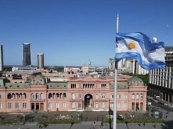 The national flag of Argentina flies in front of the Casa Rosada Presidential Palace in Buenos Aires on October 17, 2023. (Photo by Luis ROBAYO / AFP)