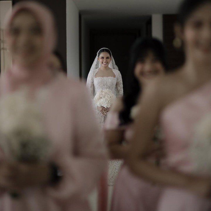 <p>Di hari bahagianya, Yunita tampil cantik mengenakan kebaya putih yang dilengkapi veil berwarna senada di kepalanya. Dalam satu foto yang dibagikan, Yunita tampak didampingi para bridesmaid yang kompak mengenakan <em>dress</em> warna merah muda. (Foto: Instagram @yunitasiregar)</p>