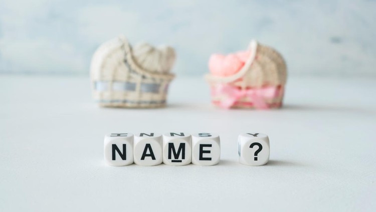 Concept of choosing baby name. Pink and blue decorative straw cradles with thread hearts and text name? on light background