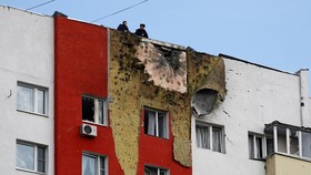 Police officers stand on the roof of a multi-storey residential building damaged in a recent Ukrainian drone attack, according to local authorities, in the course of Russia-Ukraine conflict, in Moscow, Russia March 11, 2025. REUTERS/Stringer     TPX