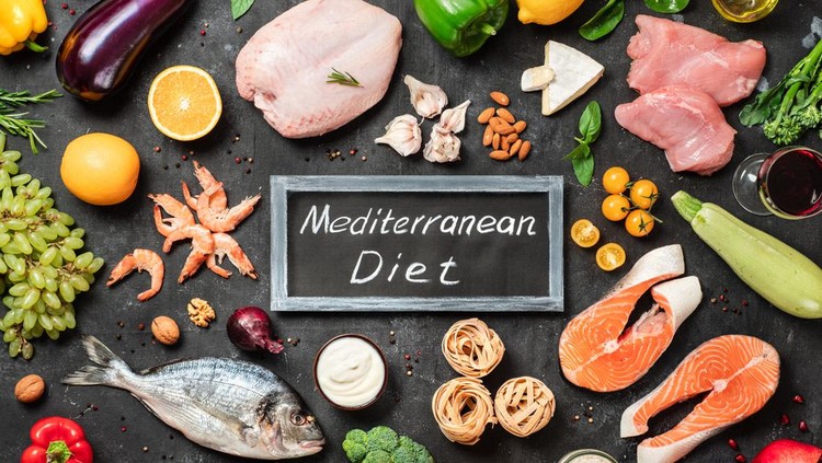 Mediterranean diet concept. Top view of food ingredients and chalkboard with words Mediterranean Diet in center. Dark background. Flat lay.