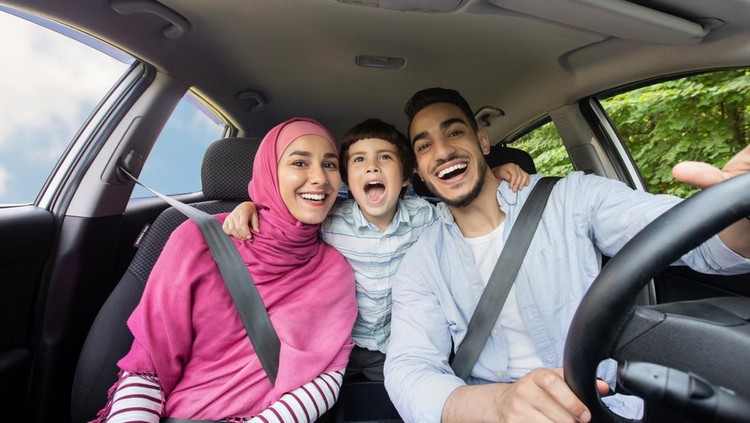 Road Fun. Joyful Muslim Family Of Three Singing Inside Of Car Together, Happy Middle Eastern Dad, Little Son And Mother In Hijab Enjoying Drive Trip Together, Laughing And Looking At Camera, Closeup
