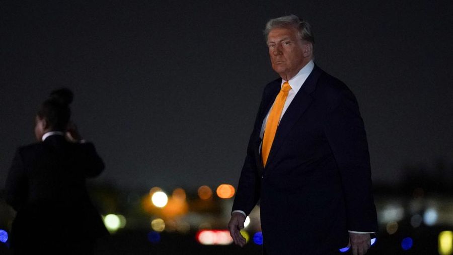 U.S. President Donald Trump walks after disembarking Air Force One at Miami International Airport, Miami, Florida, U.S., April 12, 2025. REUTERS/Nathan Howard