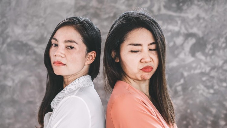 two Asian females enemy workers jealous each other at workplace
