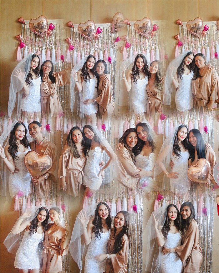 Kejutan bridal shower dari sahabat dengan dekorasi perpaduan warna putih, pink, dan gold. Luna Maya mengenakan gaun putih dan veil bak pengantin. Ia juga menggunakan bando bertuliskan