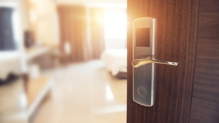 Opened door of hotel room in morning with copy space&comma; sunlight effect&period;