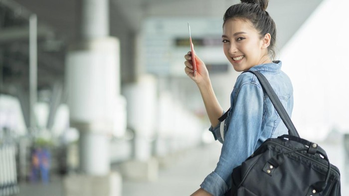attractive asian female woman wearing casual travel cloth walking waiting for transit departure building outdoor background,asian female travel concept
