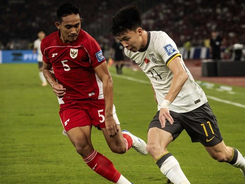 Indonesiaís defender #5 Rizky Ridho Ramadhani and Chinaís forward #11 Wang Yudong fight for the ball during the FIFA World Cup 2026 Asian qualifier football match between Indonesia and China at Gelora Bung Karno Stadium in Jakarta on June 5, 2025.