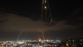 Israeli air defence systems are activated to intercept Iranian missiles over the Israeli city of Haifa amid a fresh barrage of Iranian rockets on June 16, 2025. Israel's military warned on June 16 of a new missile salvo incoming from Iran, as AFP jou