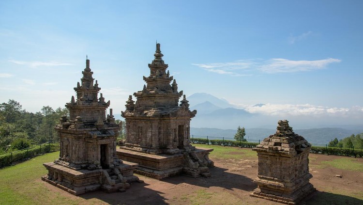 Candi Gedong Songo at sunrise&period; A 9th-century Buddhist temple complex with Mounts Merbabu and Merapi&period;