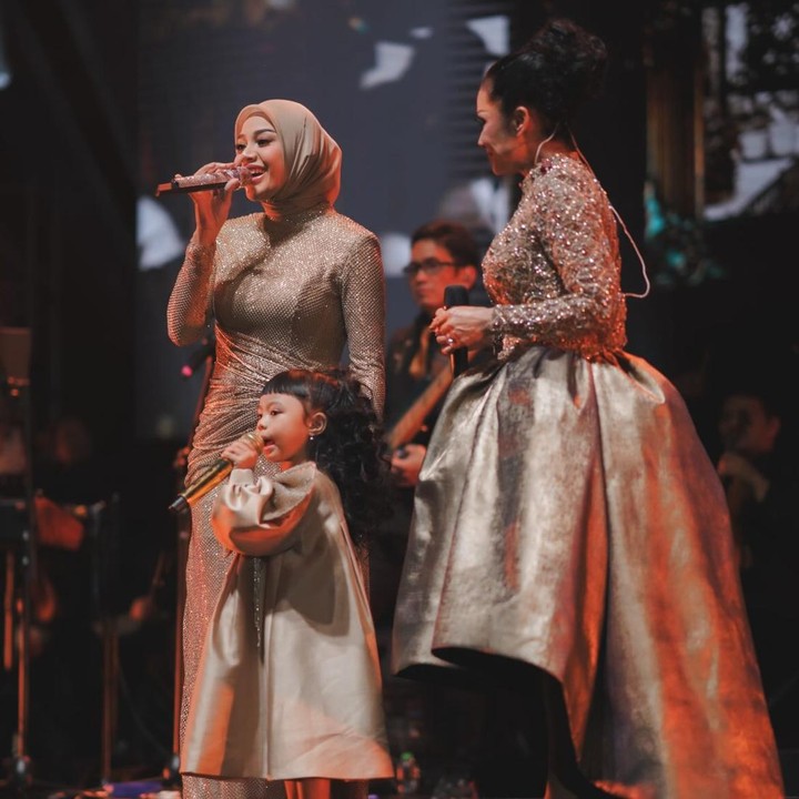 <p>Ameena tampaknya sudah mempersiapkan diri untuk tampil bernyanyi bersama neneknya. Bocah tiga tahun ini terlihat percaya diri dan terus menebar senyum bahagia saat bernyanyi di depan banyak penonton. (Foto: Instagram @aurelie.hermansyah)</p>