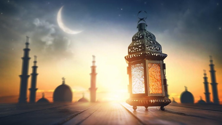 Ornamental Arabic lantern with burning candle glowing at night&period; Festive greeting card&comma; invitation for Muslim holy month Ramadan Kareem&period;