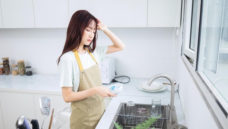 Image of young Asian woman in the kitchen