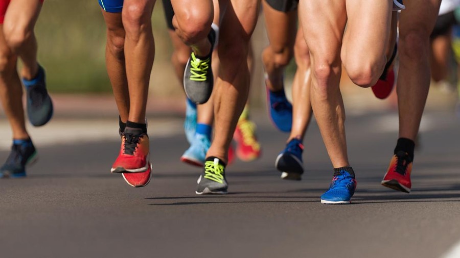 Marathon running race&comma; people feet on city road
