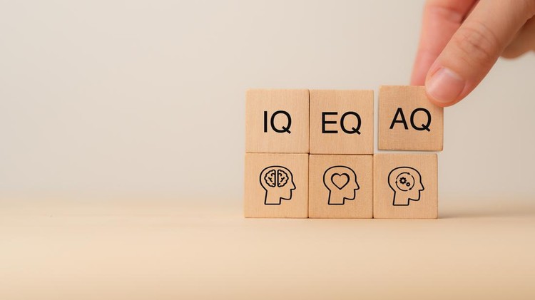 Ilustrasi IQ, EQ dan AQ Wooden blocks with the letters IQ, EQ and AQ representing Intelligence Quotient, Emotional Quotient, Adaptability Quotient. A hand adjusting AQ block, symbolizing adaptability in modern intelligence.
