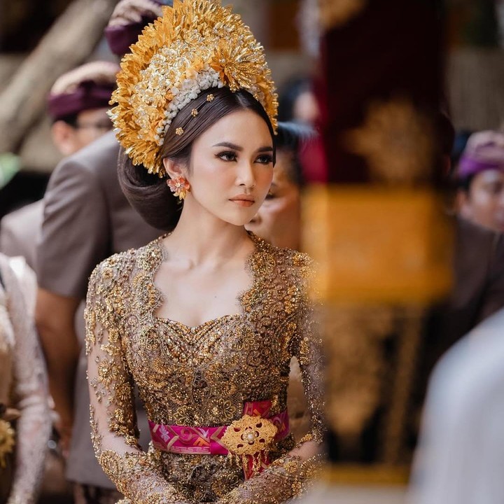 <p>Saat prosesi Mepamit jelang pernikahan dengan Rizky Febian, penyanyi Mahalini pernah mengenakan kebaya dengan desain yang identik dengan Bali. Kebaya ini merupakan rancangan dari desainer Asky Febrianti, Bunda. Melalui unggahan di Instagram, sang desainer pernah mengungkap detail kebaya yang dikenakan oleh Mahalini. "Warna <em>bronze</em> /tembaga ini memang menjadi pilihan utama dari awal kami berdiskusi, apa lagi warna ini relatif jarang terlihat, ternyata memang cocok sekali ya sama gek Lini, agar tetap <em>eye catching</em> untuk Kamen di beri sentuhan Pink Fusia dengan detail <em>full</em> payet," tulisnya. (Foto: Instagram @mahaliniraharja)</p>