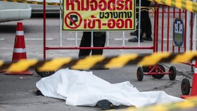 A covered body of a victim killed in a shooting incident lies at a market, where people were killed, including a gunman who took his own life, in Bangkok, Thailand, July 28, 2025. REUTERS/Patipat Janthong