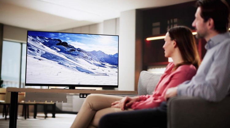 Ilustrasi TV LED couple enjoying a movie night on the living room sofa.