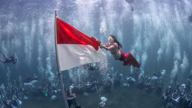 Gubernur Malut Sherly Tjoanda mengibarkan bendera Merah Putih di bawah laut dalam rangka peringatan HUT ke-80 RI.