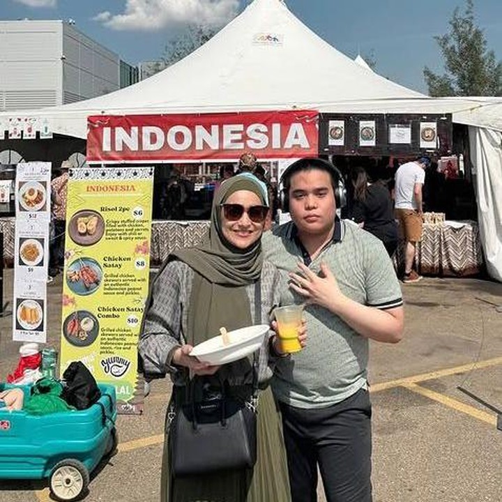 <p>Mereka juga sempat berkeliling dan mengunjungi <em>booth</em> Indonesia di Edmonton Heritage Festival 2025. Bunda tiga anak ini terlihat asyik membeli jajanan khas Indonesia bersama sang anak, Omar. "Indonesia.. seberapa pun jauhnya kita melangkah, tetep aja kangen. Ini adalah booth Indonesia di Edmonton Heritage Festival 2025," tulisnya. (Foto: Instagram @cindyfatikasari18)</p>