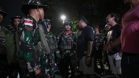 Prajurit TNI AD berbincang dengan warga saat patroli di kawasan Salemba, Jakarta, Minggu (31/8/2025). Komando Daerah Militer Jayakarta mengerahkan satu pasukan Satuan Setingkat Kompi untuk berpatroli keliling wilayah Jakarta guna mengantisipasi aksi