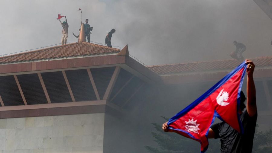 Para demonstran merayakan setelah memasuki kompleks Parlemen selama protes terhadap pembunuhan 19 orang pada hari Senin setelah protes antikorupsi yang dipicu oleh larangan media sosial, yang kemudian dicabut, selama jam malam di Kathmandu, Nepal, 9 September 2025. (REUTERS/Adnan Abidi)