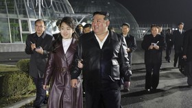 This picture taken on March 15, 2024 and released from North Korea's official Korean Central News Agency (KCNA) on March 16 shows North Korean leader Kim Jong Un (front R) and his daughter Ju Ae (front L) visiting the Gangdong Comprehensive Greenhous