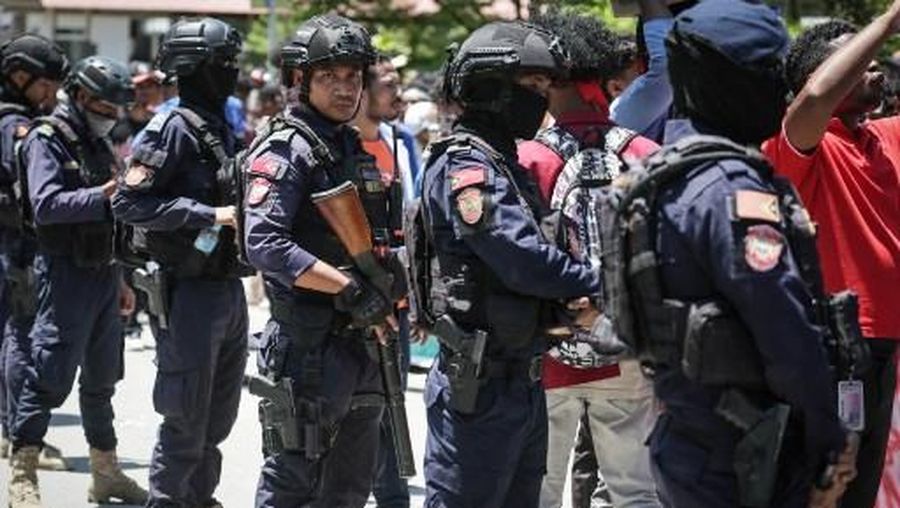 A firefighter extinguishes a blaze set alight by university students protesting the parliaments plan to buy 65 SUVs for lawmakers in Dili, East Timor, on September 16, 2025. East Timor police fired tear gas on September 16 at protesters railing for the second day against a plan to buy new official cars for lawmakers, which became the latest flashpoint in one of the poorest nations in Southeast Asia. (Photo by VALENTINO DARIELL DE SOUSA / AFP)
