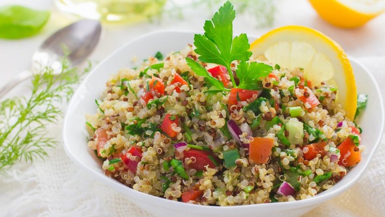 Tabbouleh salad with quinoa, parsley and vegetables on white background