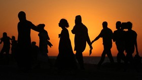 Displaced Palestinians move with their belongings southwards on a road in the Nuseirat refugee camp area in the central Gaza Strip on September 20, 2025, as Israel presses its ground offensive to capture Gaza City. Israel has pummelled Gaza City with