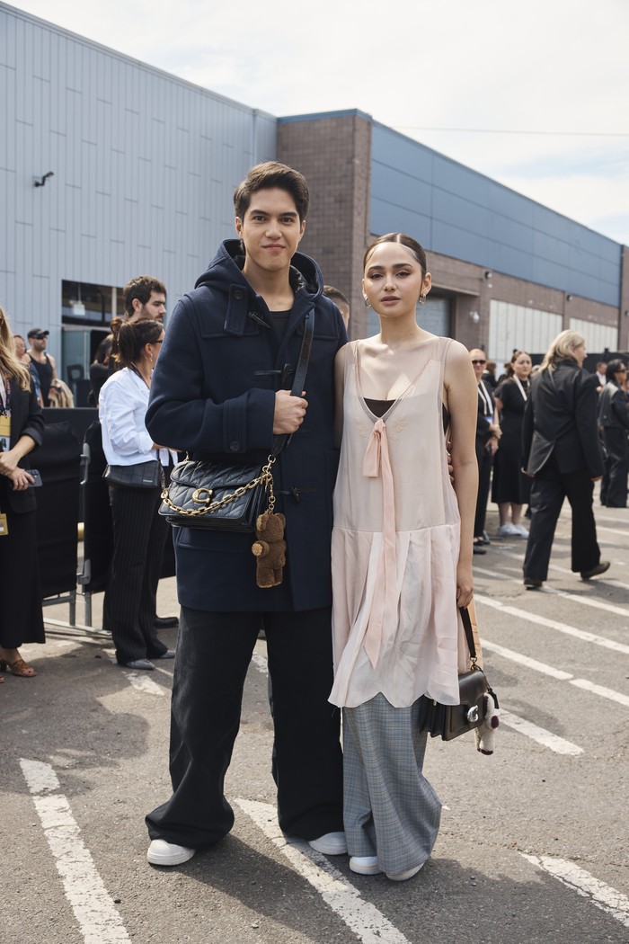 El Rumi hadiri fashion show Coach Spring/Summer 2026 di New York. Ia mengenakan duffel coat, wide leg pants, dan tas Coach Chain Tabby.