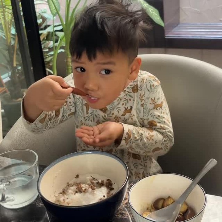 <p>Tak berselang lama, Indah pun memesan bubur organik untuk Naka. Si Kecil terlihat kembali <em>happy</em> dan sangat lahap menghabiskan makannya, Bunda. "Baru melek langsung minta bubur ayam tuh gimana ya. Jadi buburnya ini aku beli aja yang Naka suka," kata Indah. (Foto: Instagram @indahpermatas)</p>