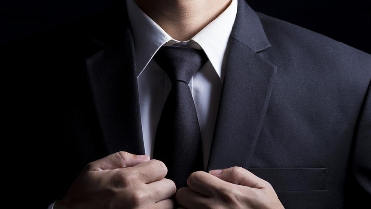 Businessman in Suit on Isolated Black Background