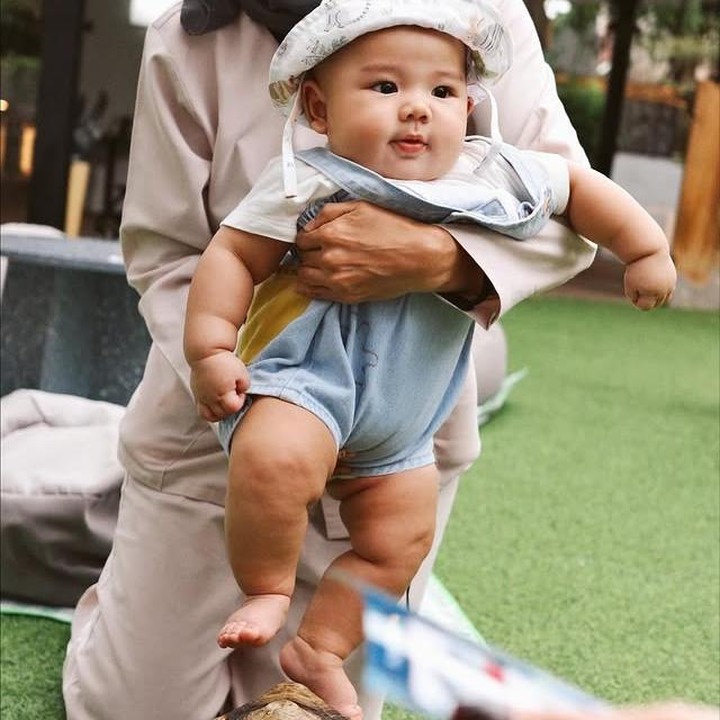 <p>Dalam momen lainnya, <em>Baby</em> Arash terlihat asyik bermain dengan kura-kura darat atau sulcata. Topi bundar yang dipakai Arash bikin terlihat makin menggemaskan ya, Bunda. (Foto: Instagram @aaliyah.massaid)</p>