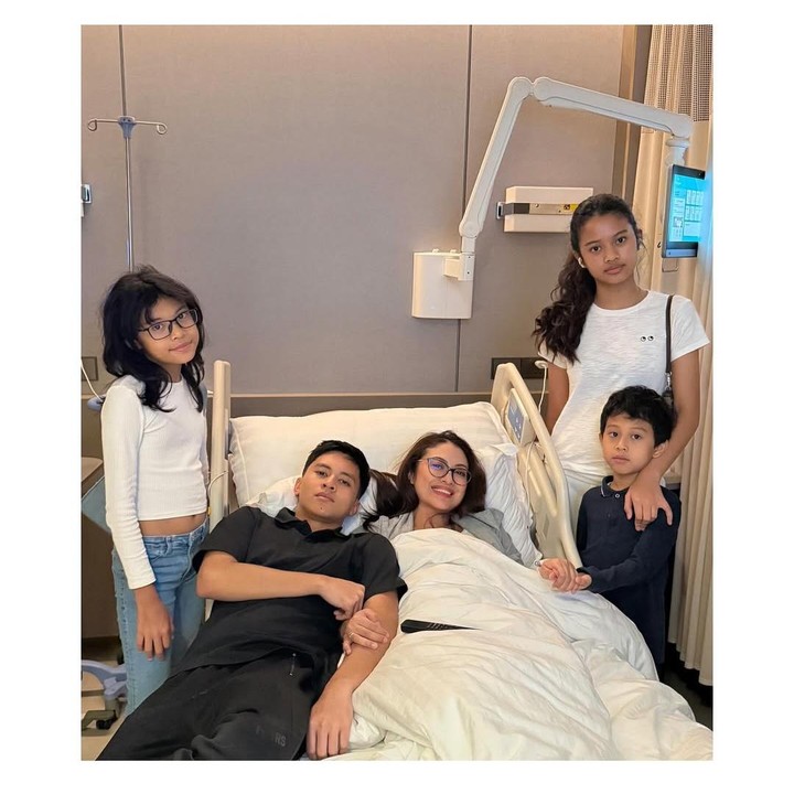 <p>Giring juga membagikan potret keempat anaknya saat menjenguk sang Bunda di rumah sakit. Wakil Menteri Kebudayaan Republik Indonesia ini berharap istrinya bisa fokus beritirahat hingga sembuh. "Sekarang… kamu fokus dulu istirahatnya. Bobo yang enak, kurangi belanja <em>online</em> nya dan kepo konten konten mistis di IG atau tiktok, biarkan obat dari dokter, cinta dan doa dari aku dan anak anak yang bekerja menyembuhkanmu. Aku, Zidane, Aisha, Jasmina, dan Abraham mengirim cinta dan semangat dari setiap hembusan nafas kami," ungkap Giring. (Foto: Instagram @giring/ @cynthiaganesha)</p>