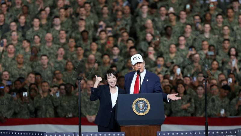 Presiden AS Donald Trump berbicara sementara Perdana Menteri Jepang Sanae Takaichi memberi isyarat kepada personel militer, di atas kapal induk USS George Washington, selama kunjungan mereka ke pangkalan Angkatan Laut AS di Yokosuka, Jepang, 28 Oktober 2025. (REUTERS/Kim Kyung-Hoon)