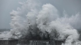 Strong waves crash against the sea wall in Yilan on November 11, 2025, as Typhoon Fung-Wong approaches. (Photo by I-Hwa Cheng / AFP)