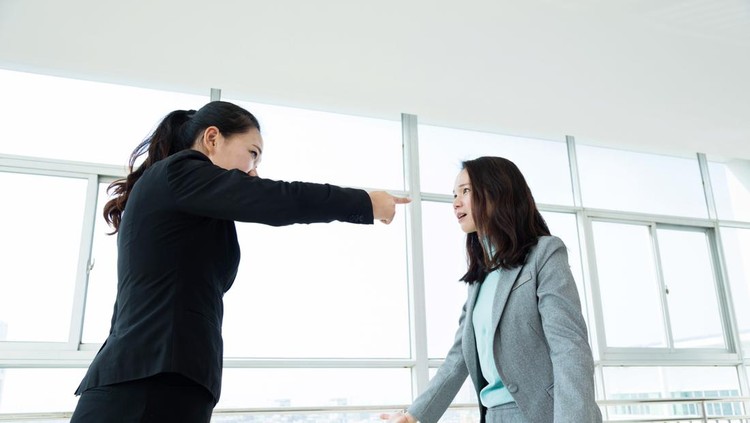 Two businesswomen arguing in office.