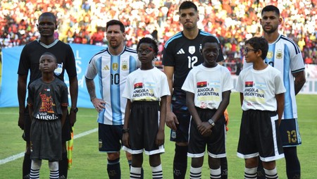 Argentina's forward #10 Lionel Messi (2nd L) stands with Argentina's goalkeeper #12 Geronimo Rulli (3rd L) before the friendly match between Angola and Argentina in Luanda on November 14, 2025. Football icon Lionel Messi created the first goal and sc