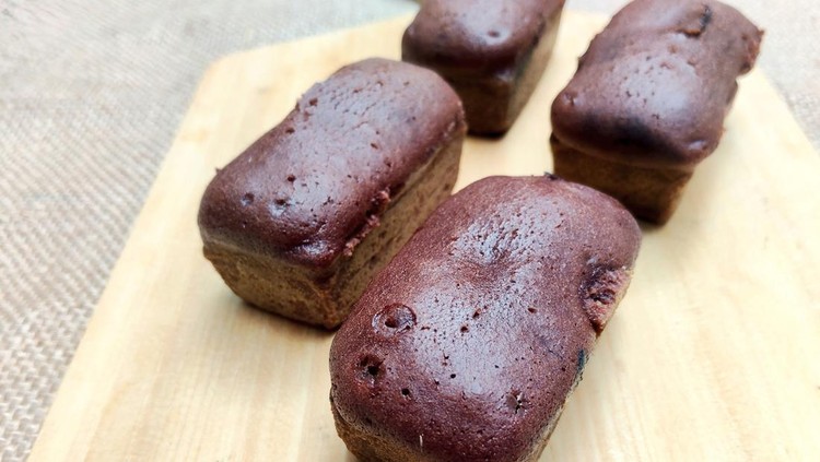 Indonesian Balok Cakes, a traditional chocolate snack from Bandung, presented on a wooden board. This delicious, moist cake is a popular street food dessert.