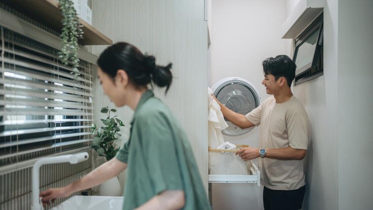 Asian man doing laundry at home. Activity of daily living at house at Bangkok, Thailand
