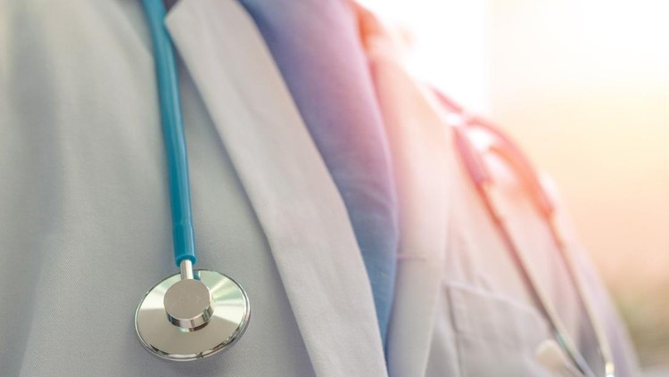 Medical doctor or physician in white gown uniform with stethoscope in hospital or clinic