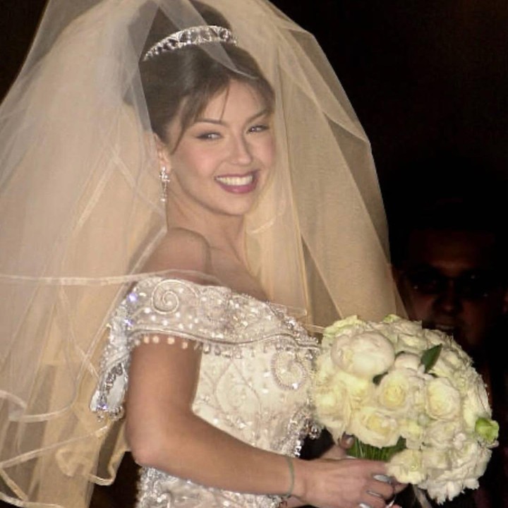 <p>Di hari ulang tahun pernikahan ke-25 tahun, Thalia mengunggah foto-foto pernikahannya dengan sang suami. Dalam potret ini, Thalia tampil cantik mengenakan gaun putih <em>off shoulder</em>, senada dengan warna <em>veil</em> yang menjadi aksesoris utama. (Foto: Instagram @tommymottola)</p>