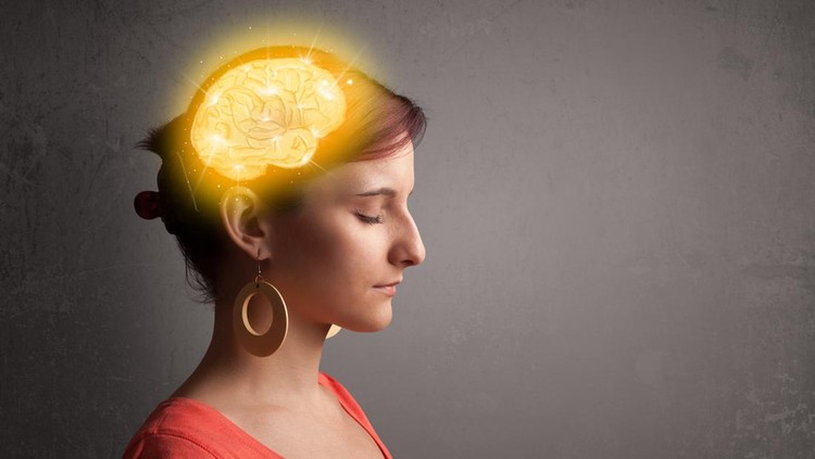 Young girl thinking with glowing brain illustration on grungy background